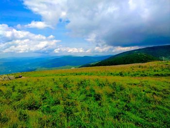 Scenic view of landscape against cloudy sky