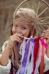 Girl indian shaman blonde in a poncho and a dream catcher