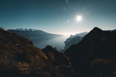 Scenic view of mountains against bright sun