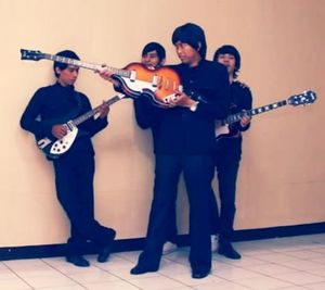 Young man playing guitar at music concert