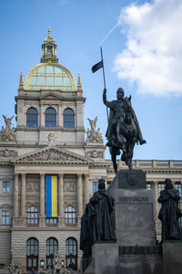Wonderful historic building of national museum with statue in front of it,side angle, prague,czechia