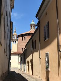 Street amidst buildings against sky