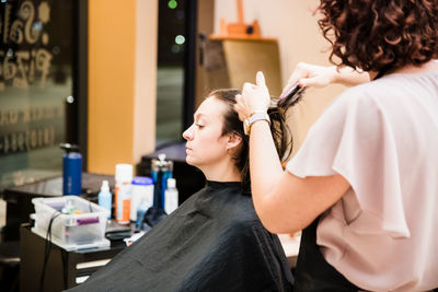 Midsection of woman relaxing at home