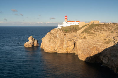 Rock formations by sea against sky