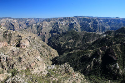 Scenic view of mountains against clear blue sky