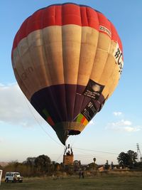 View of hot air balloon flying over land