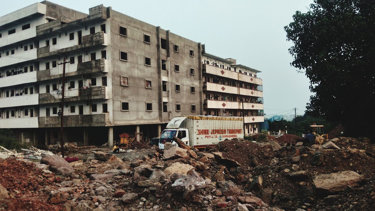 architecture, built structure, building exterior, building, urban area, construction industry, nature, residential area, city, residential district, day, no people, demolition, sky, apartment, construction site, damaged, outdoors, industry, tree, abandoned, demolished, destruction