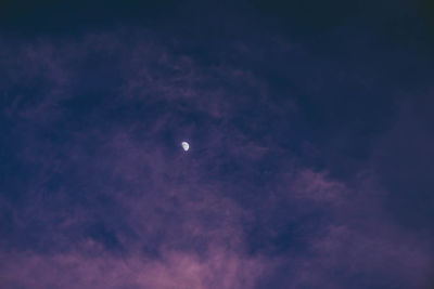 Low angle view of moon in sky at night