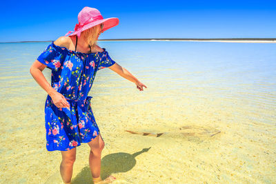 Cheerful woman standing on beach