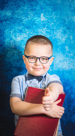 Portrait of smiling boy holding swimming pool