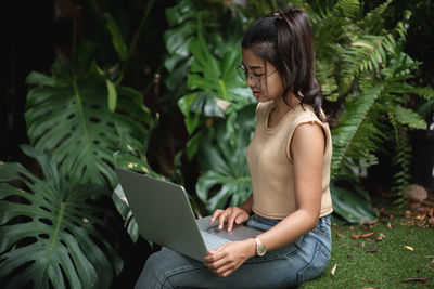 Midsection of woman using mobile phone