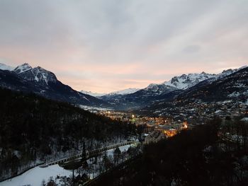 Scenic view of snowcapped mountains against sky during sunset