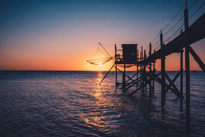 A hut, called carrelet,  with craft net at sunset with a long exposure. esnandes, france.