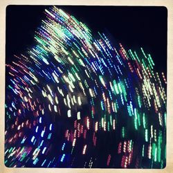 Low angle view of illuminated ferris wheel