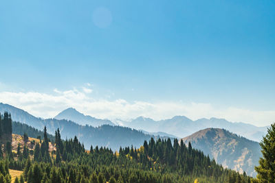 Panoramic view of mountains against blue sky