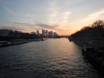 View of city at waterfront during sunset