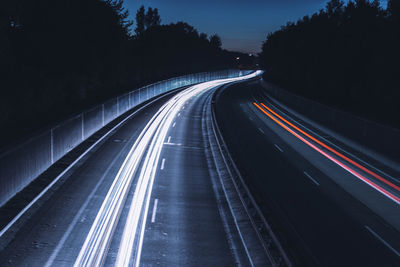 High angle view of light trails on highway at night
