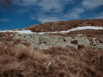 Low angle view of rocky mountain against sky