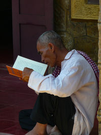 Full length of a young man reading book