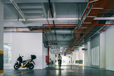 Man riding bicycle in parking lot