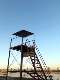 Low angle view of lifeguard cabin at beach against sky