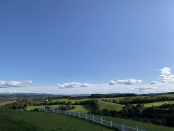 Scenic view of landscape against blue sky