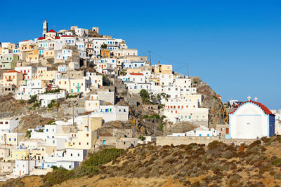 Houses in town against clear sky