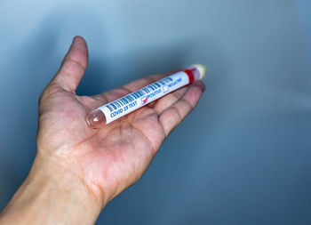 Close-up of hand holding finger against blurred background