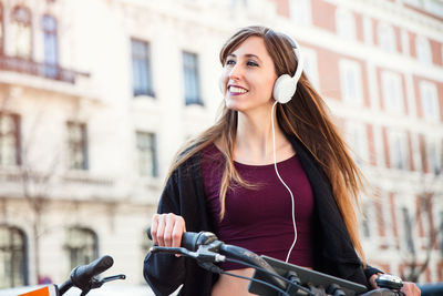 Young woman riding bicycle on street