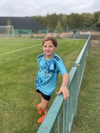 Portrait of boy standing on field