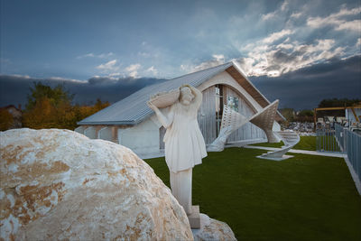 Stone - sculpture - sky - grass - roof 