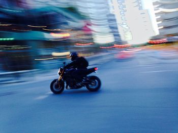 Blurred motion of people walking on road
