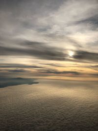 Scenic view of sea against dramatic sky during sunset