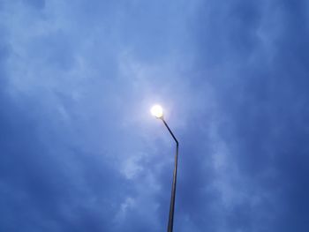 Low angle view of street light against blue sky