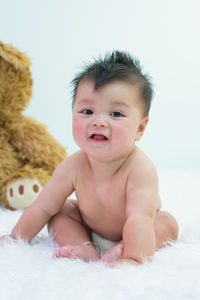 Portrait of cute baby on bed