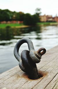 Close-up of metal by lake