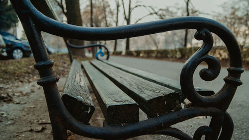 Close-up of metal bench in park