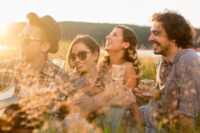 Group of young people drinking on a meadow