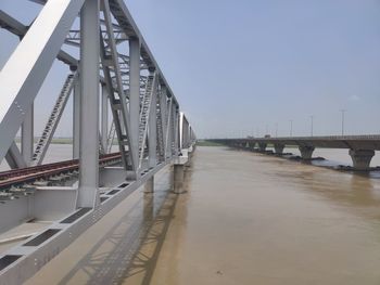 Bridge over road against clear sky