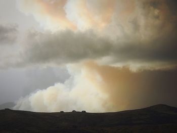 Low angle view of storm clouds over landscape