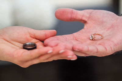 Cropped hands of couple holding rings