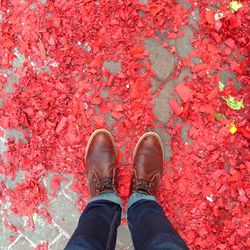 Low section of man standing on confetti at street