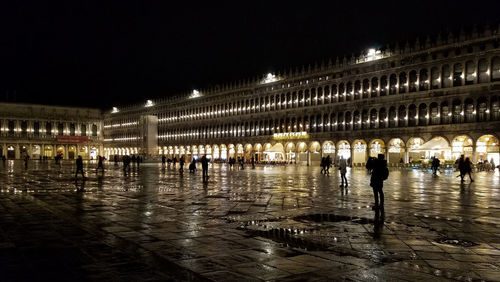 Group of people on wet street at night