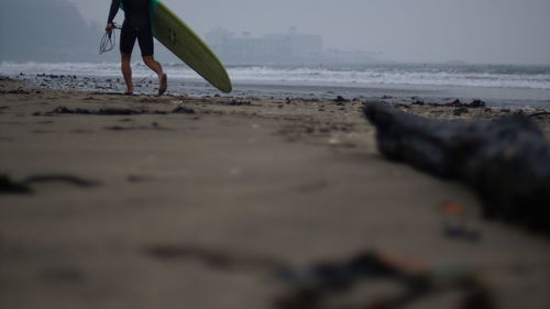 Rear view of woman walking on beach