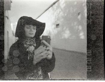 Full length of woman looking through window