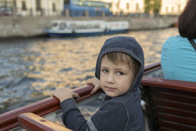 Portrait of friends sitting on boat in water