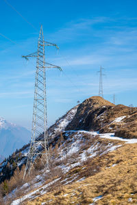 Electricity pylons in a mountain place. origin, transport and need for electricity. eletricity grid.