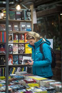 Woman using smart phone at store