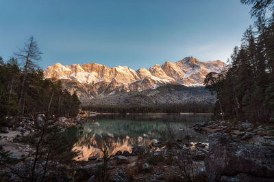 Scenic view of lake by mountain against sky