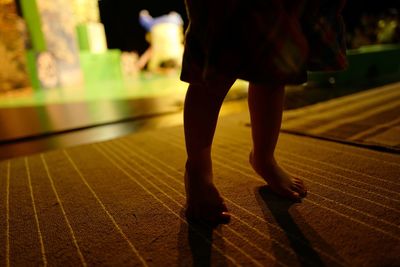 Low section of woman walking on floor